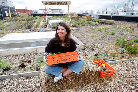 Sophie Jankowski, President of "Seed Postman" association, speaks during a interview on a 900 square meters farm garden on the rooftop of their postal sorting center, as part of a project by Facteur Graine association to transform a city rooftop as a vegetable garden to grow fruits, vegetables, aromatic and medicinal plants, with also chickens and bees in Paris, France, September 22, 2017. Picture taken September 22, 2017. REUTERS/Charles Platiau