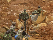 <p>Security forces take a rest after searching for bodies from the scene of heavy flooding and mudslides in Regent, just outside of Sierra Leone’s capital Freetown. Aug. 15 , 2017. (Photo: Manika Kamara/AP) </p>