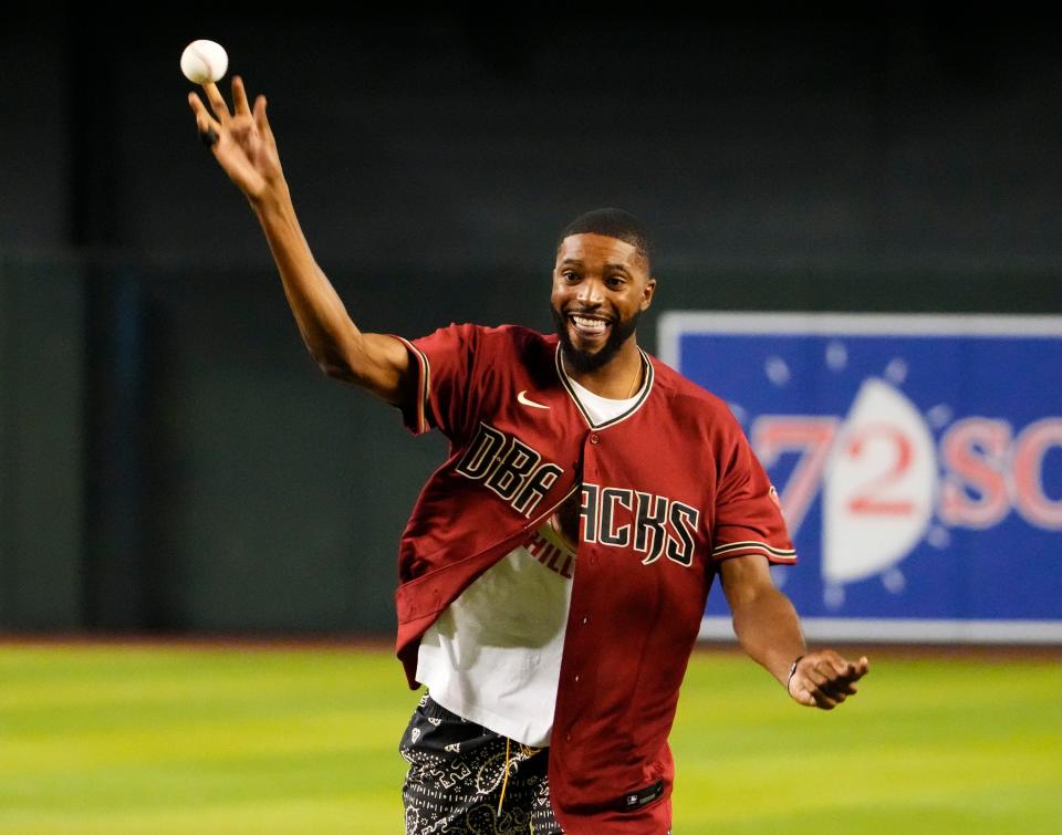 Aug 30, 2022; Phoenix, Arizona, USA; Phoenix Suns Mikal Bridges throws out the first pitch at Chase Field.