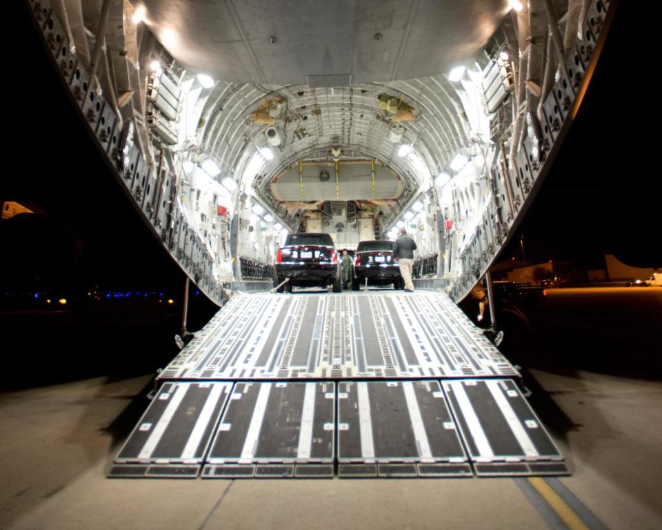 The President's limousines are loaded aboard a US Air Force C-17 in preparation for a trip.