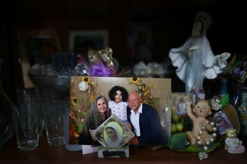 A photograph shows a missing silo employee Ghassan Hasrouty posing with his family, in the family home following Tuesday's blast in Beirut's port