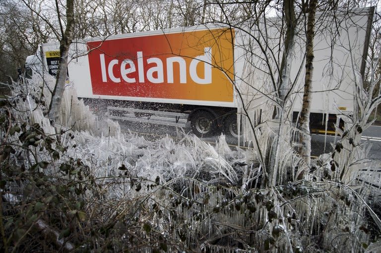 An Iceland supermarket lorry passes a section of icicles and ice-covered hedgerow near Hazeley Bottom, south of Reading, on March 27, 2013. Millions of people in northern Europe are still battling snow and ice, wondering why they are being punished with bitter cold when -- officially -- spring has arrived and Earth is in the grip of global warming