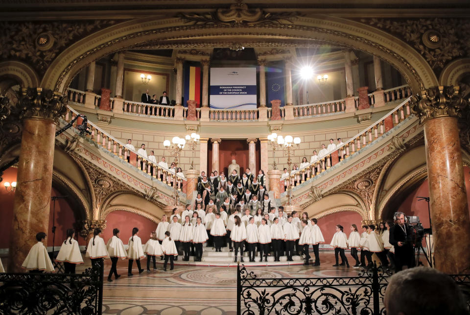 Members of a choir arrive at the Romanian Atheneum concert hall in Bucharest, Romania, Thursday, Jan. 10, 2019, before an event marking the official start of the Romanian Presidency of the Council of the European Union. (AP Photo/Vadim Ghirda)