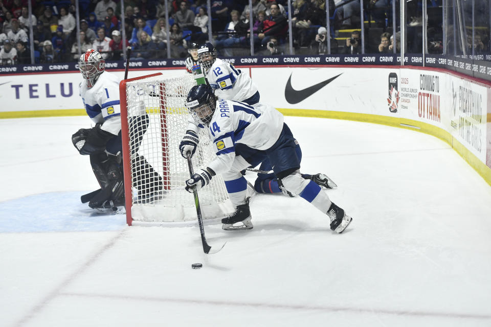 Finland's Krista Parkkonen (14) skates with the puck during the second period in the semifinals against the United States at the IIHF women's world hockey championships Saturday, April 13, 2024, in Utica, N.Y. (AP Photo/Adrian Kraus)