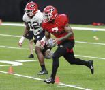 Georgia tailback D' Andre Swift, right, runs a drill during team practice for the Sugar Bowl at Mercedes-Benz Superdome on Saturday, December 28, 2019, in New Orleans. (Curtis Compton/Atlanta Journal-Constitution via AP)