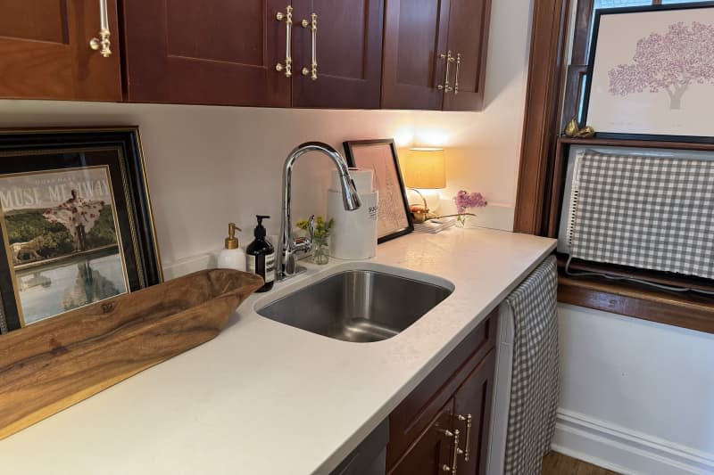 white kitchen with wood cabinets and wood trim