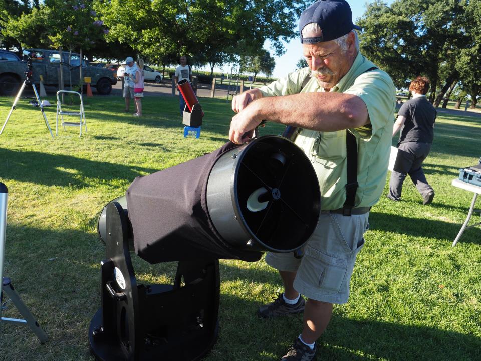 In this July 2019 file photo, Bill Litel sets up his reflective telescope during Special Astronomy In the Park to mark the 50th anniversary of the Moon Landing.