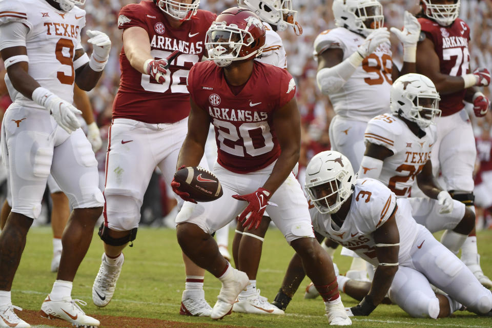 Arkansas running back Dominique Johnson (20) celebrates after scoring a touchdown against Texas during the first half of an NCAA college football game Saturday, Sept. 11, 2021, in Fayetteville, Ark. (AP Photo/Michael Woods)