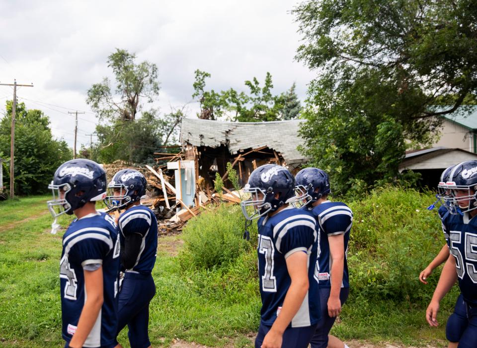 The Burke High School football team walks to Tolstedt Field on Friday in Burke, S.D.