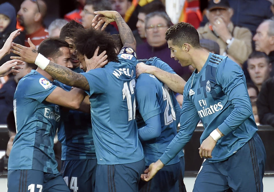 Cristiano Ronaldo, uh, celebrates(?) with Marcelo after Real Madrid’s third goal against Valencia. (Getty)