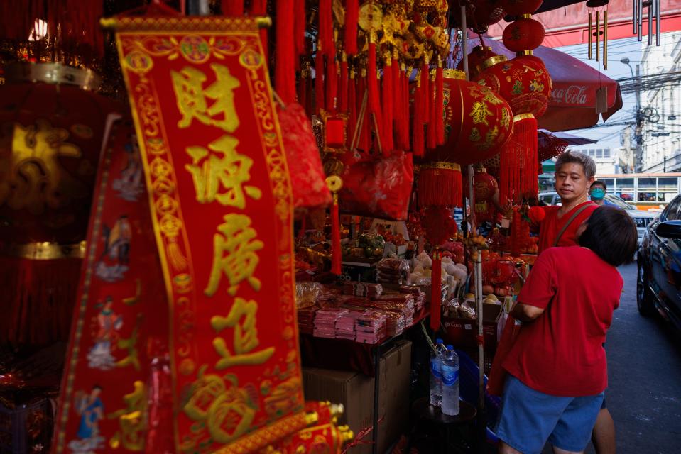 People buy Chinese lanterns from street vendors in on Lunar New Year's Eve on February 09, 2024 in Bangkok, Thailand.