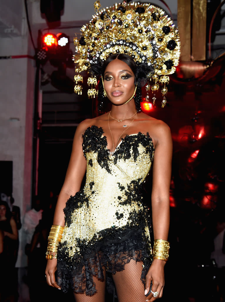 <p>Naturally, Campbell looked amazing! She sparkled too in a fierce gold headdress at an amfAR party in NYC. (Photo: Kevin Tachman/amfAR2017/WireImage) </p>