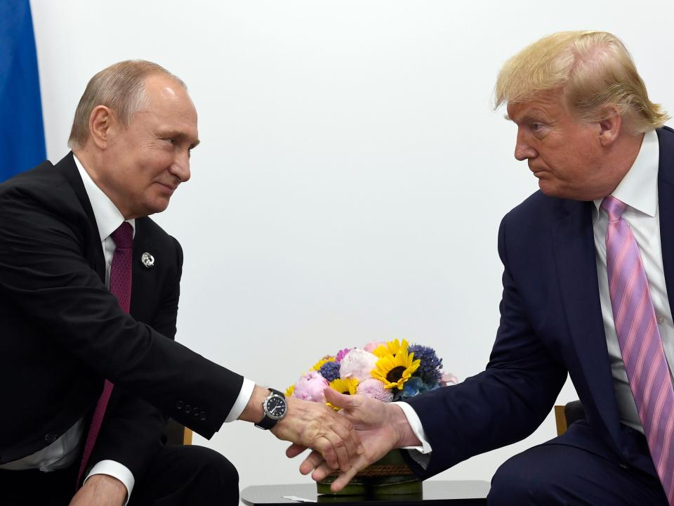 In this June 28, 2019, file photo, President Donald Trump, right, shakes hands with Russian President Vladimir Putin, left, during a bilateral meeting on the sidelines of the G-20 summit in Osaka, Japan.