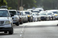 People wait in their vehicles in line at a COVID-19 testing site, Tuesday, July 14, 2020, in Houston. (AP Photo/David J. Phillip)