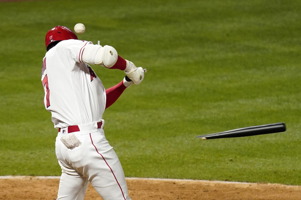 Los Angeles Angels' Shohei Ohtani breaks his bat on a foul ball during the eighth inning of a baseball game against the Texas Rangers Monday, April 19, 2021, in Anaheim, Calif. (AP Photo/Mark J. Terrill)