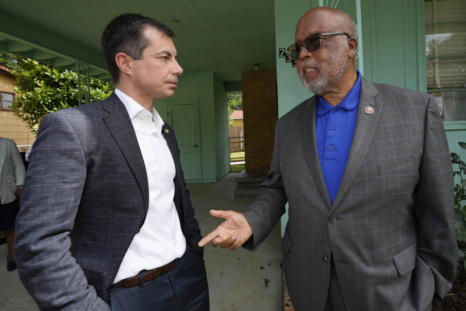 United States Transportation Secretary Pete Buttigieg, left, and U.S. Rep. Bennie Thompson, D-Miss., right, confer outside the house that is the Medgar and Myrlie Evers National Monument, Friday, June 21, 2024, in Jackson, Miss. The house was one of the stops Buttigieg made as he spent Thursday and Friday in Mississippi, promoting projects that will be helped or will be receiving money from a federal infrastructure act. (AP Photo/Rogelio V. Solis)