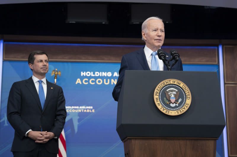 U.S. President Joe Biden (R) delivers remarks next to Transportation Secretary Pete Buttigieg (L) on protecting consumers in the South Court Auditorium at the White House, May 2023. Buttigieg was in Nevada on Monday to break ground on America's first high-speed railway. File Photo by Chris Kleponis/UPI