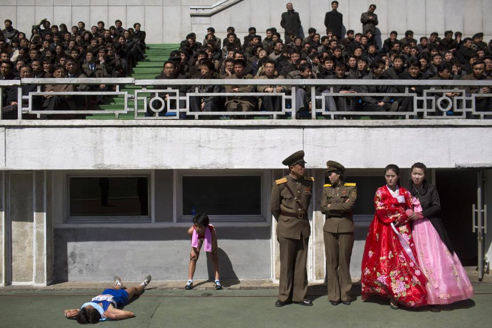 FILE - In this April 14, 2013 file photo, runners rest inside Kim Il Sung Stadium in Pyongyang as North Korea hosts the 26th Mangyongdae Prize Marathon to mark the birthday of the late leader Kim Il Sung on April 15. For the first time ever, North Korea is opening up the streets of its capital to runner-tourists for the annual Pyongyang marathon, undoubtedly one of the most exotic feathers in any runner’s cap. Tourism companies say they have been inundated by requests to sign up for the April 13, 2014 event, which this year will include amateur runners from around the world. (AP Photo/David Guttenfelder, File)