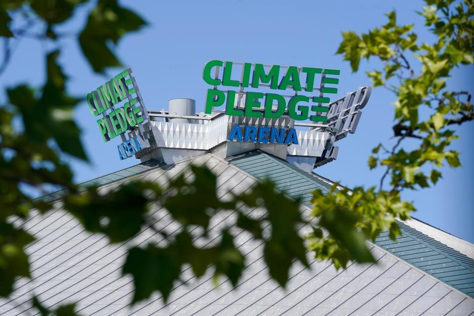The rooftop sign for Climate Pledge Arena, home of the NHL hockey team Seattle Kraken and the WNBA Seattle Storm basketball team.