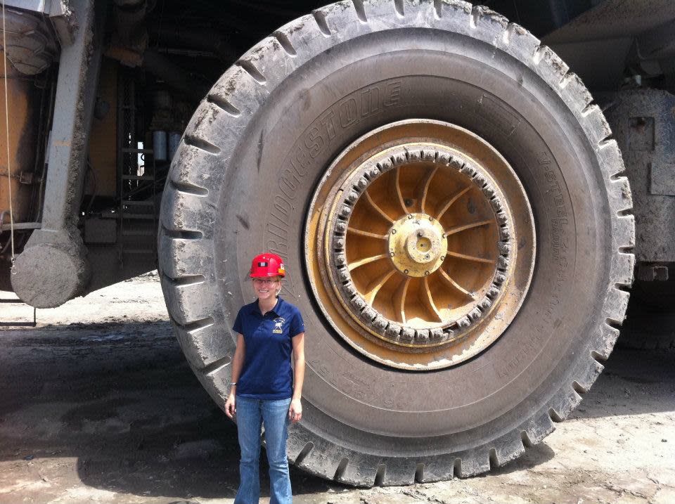 Amy Burt McBrayer, a Damascus native, stands in front of a haul truck tire at the Hobet mine in Madison, W.Va., where she interned in the environmental engineering group in 2011.