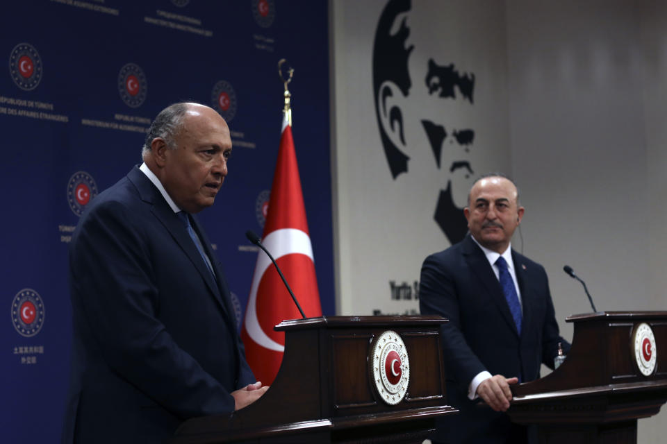 Turkish Foreign Minister Mevlut Cavusoglu, right, and his Egyptian counterpart Sameh Shoukry speak to the media after their talks in Ankara, Turkey, Thursday, April 13, 2023. Shoukry is in Turkey as the two countries attempt to improve relations. (AP Photo/Burhan Ozbilici)