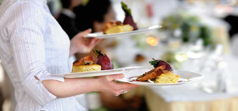 A waitress carrying plates of food