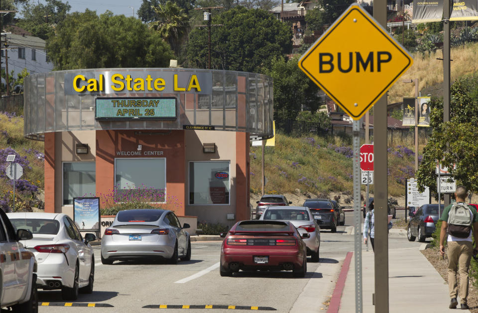 Students drive to Cal State University, Los Angeles campus Thursday, April 25, 2019. Hundreds of students and staff at two Los Angeles universities, including Cal State University, have been placed under quarantine because they may have been exposed to measles. Officials say the people affected by the order either have not been vaccinated or cannot verify that they are immune. (AP Photo/Damian Dovarganes)