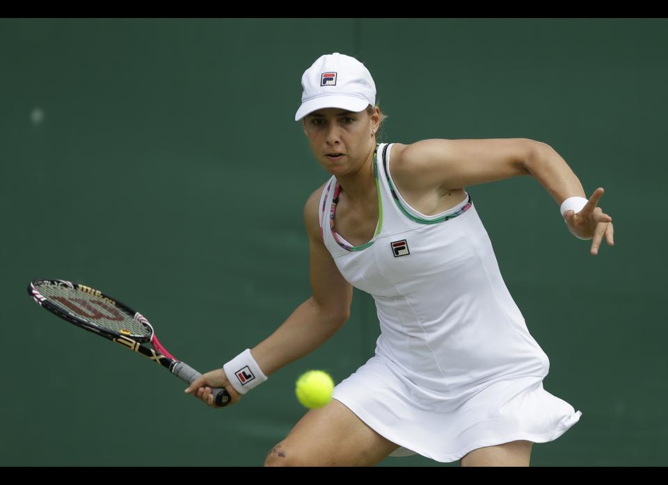 Marina Erakovic of New Zealand returns a shot to Roberta Vinci of Italy during a second round women's singles match at the All England Lawn Tennis Championships at Wimbledon, England, Thursday, June 28, 2012.