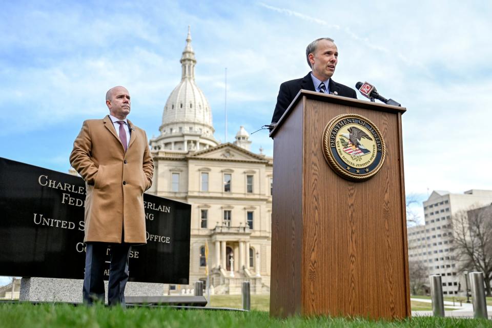 U.S. Attorney for the Western District of Michigan Mark Totten, right, speaks during a news conference to announce charges in a public corruption scheme on Thursday, April 6, 2023, outside the Charles E. Chamberlin Federal Building in Lansing. At left, James Tarasca, Special Agent in Charge of the FBI in Michigan, stands by.