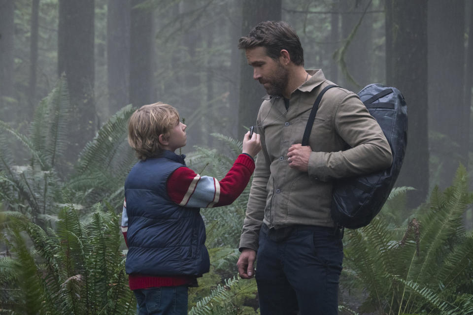 This image released by Netflix shows Walker Scobell, left, and Ryan Reynolds in a scene from "The Adam Project." (Doane Gregory/Netflix via AP)