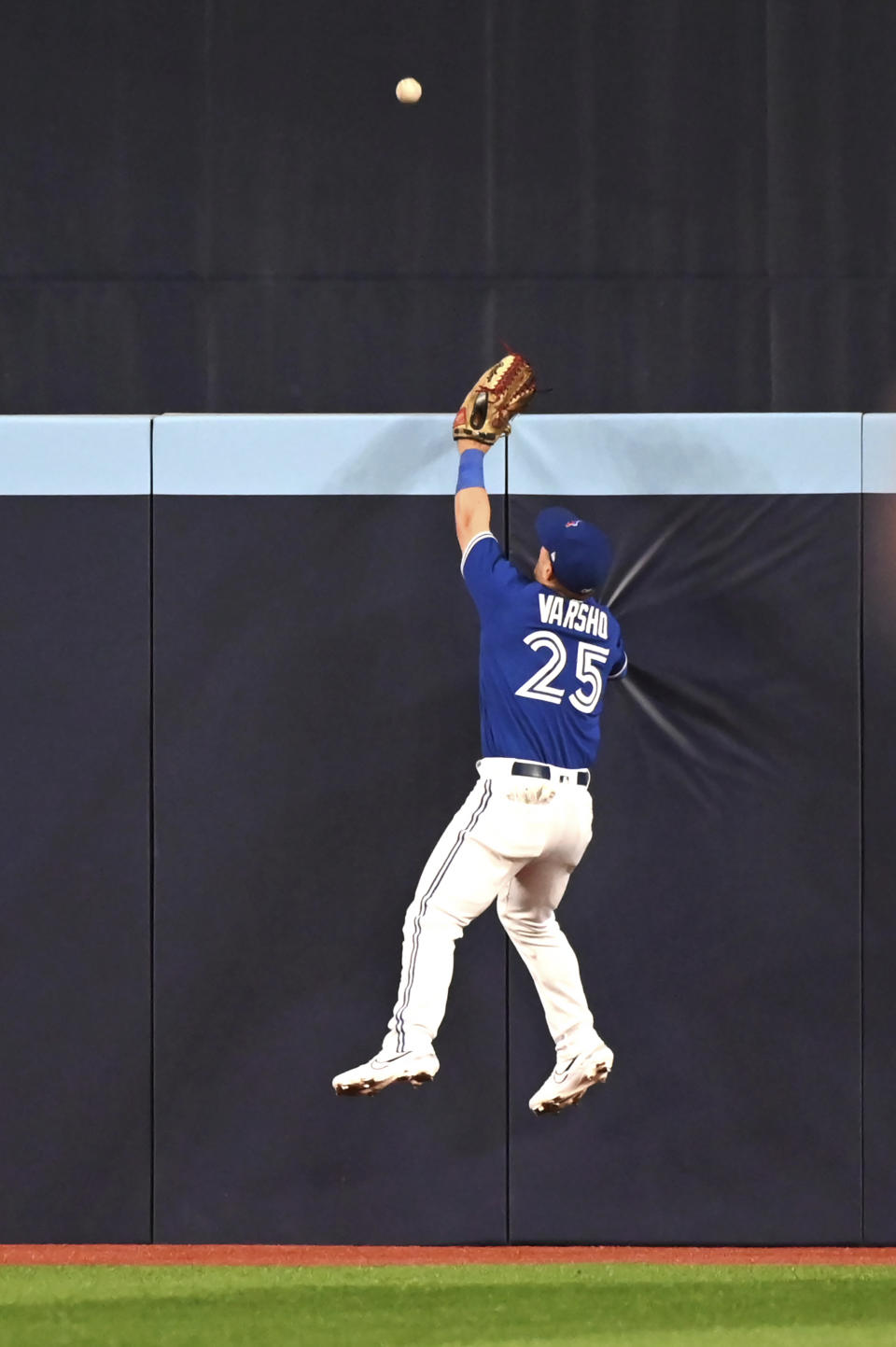 Toronto Blue Jays right fielder Daulton Varsho (25) is unable to make the catch on a solo home run by Oakland Athletics left fielder Seth Brown in the second inning of a baseball game in Toronto, Saturday, June 24, 2023. (Jon Blacker/The Canadian Press via AP)