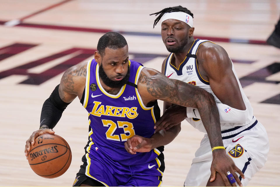 Los Angeles Lakers' LeBron James (23) drives against Denver Nuggets' Jerami Grant during the second half of an NBA conference final playoff basketball game Saturday, Sept. 26, 2020, in Lake Buena Vista, Fla. (AP Photo/Mark J. Terrill)