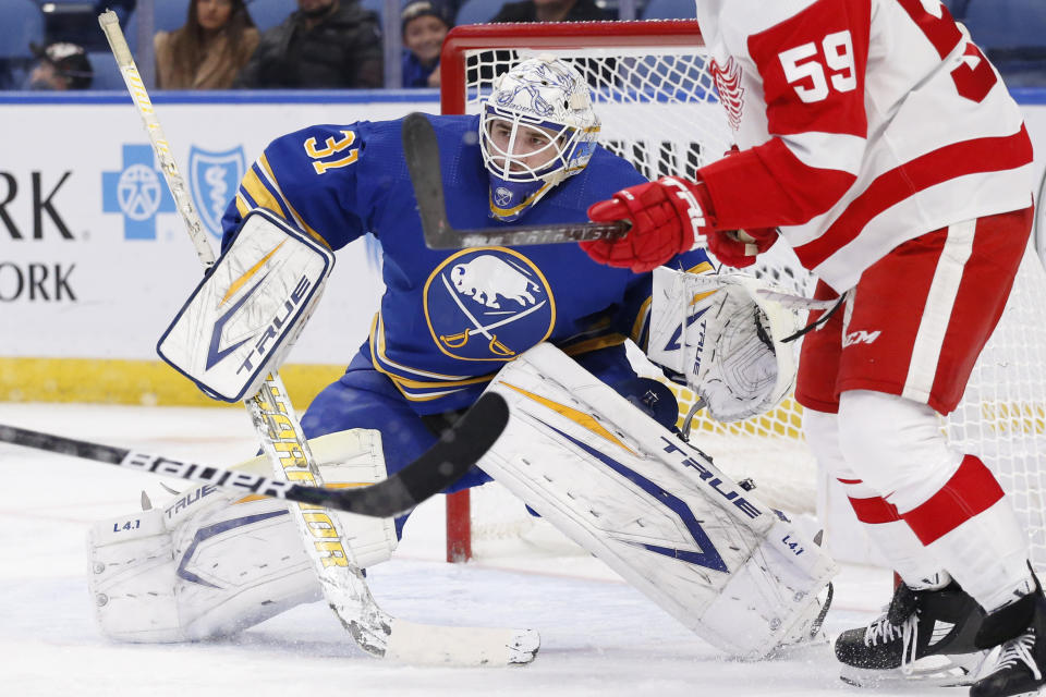 Buffalo Sabres goaltender Dustin Tokarski (31) looks for the puck in traffic during the second period of an NHL hockey game against the Detroit Red Wings, Saturday, Nov. 6, 2021, in Buffalo, N.Y. (AP Photo/Jeffrey T. Barnes)