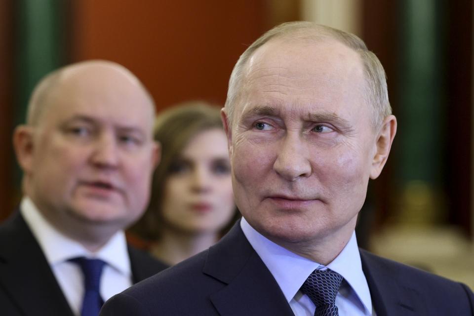 Russian President Vladimir Putin, foreground, visits an exhibition dedicated to the key events of the outgoing Year of Teachers and Mentors at the Kremlin in Moscow, Russia, Wednesday, Dec. 27, 2023. (Gavriil Grigorov, Sputnik, Kremlin Pool Photo via AP)