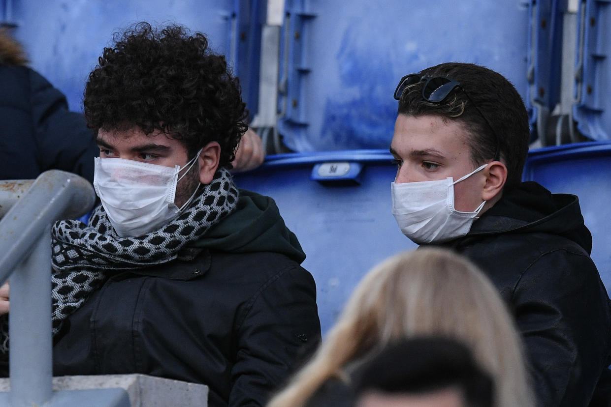 Roma supporters wear masks to protect from the coronavirus while watching a Serie A match against Lecce on Sunday. (Photo by Giuseppe Maffia/NurPhoto via Getty Images)