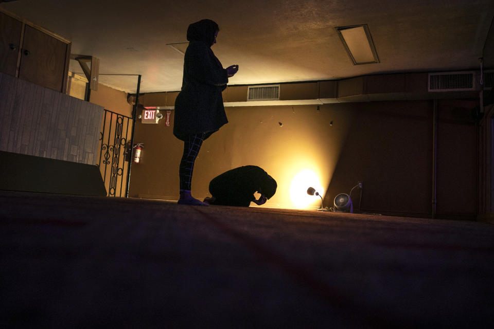 Dania Darwish, 27, right, and Mena Elneanai, 26, participate in nighttime prayers in the Muslim Community Center in the Bay Ridge neighborhood of Brooklyn during the month of Ramadan, before heading out into Manhattan where they volunteer with Muslims Giving Back to hand out warm plates of food to the hungry in Herald Square, New York, on Thursday, April 30, 2020. (AP Photo/Wong Maye-E)