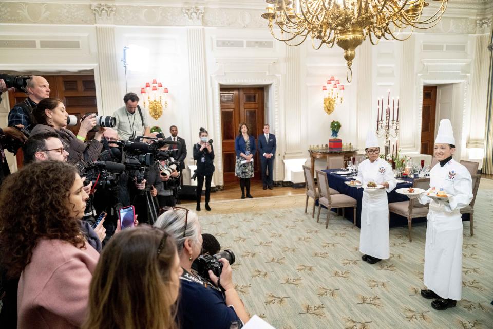 White House executive chef Cris Comerford, left, and White House executive pastry chef Susie Morrison, right, hold dishes during a media preview for the State Dinner with President Joe Biden and French President Emmanuel Macron in the State Dining Room of the White House in Washington, Wednesday, Nov. 30, 2022. The dinner will include a butter poached Maine lobster, beef with shallot marmalade, American artisanal cheeses, and an orange chiffon cake for desert. (AP Photo/Andrew Harnik)