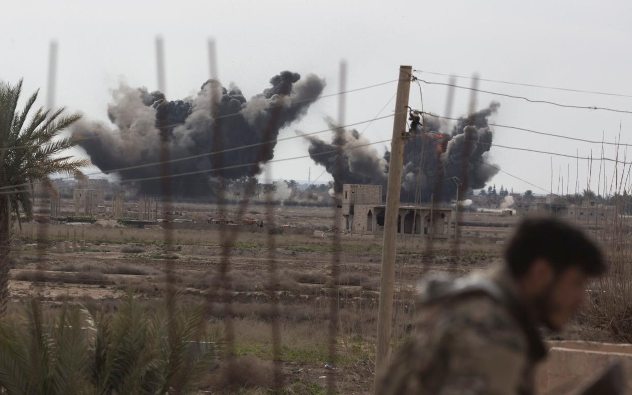 A Syrian Democratic Forces fighter ducks as a pair of coalition airstrikes hit territory controlled by ISIL near the town of Baghuz  - Sam Tarling 