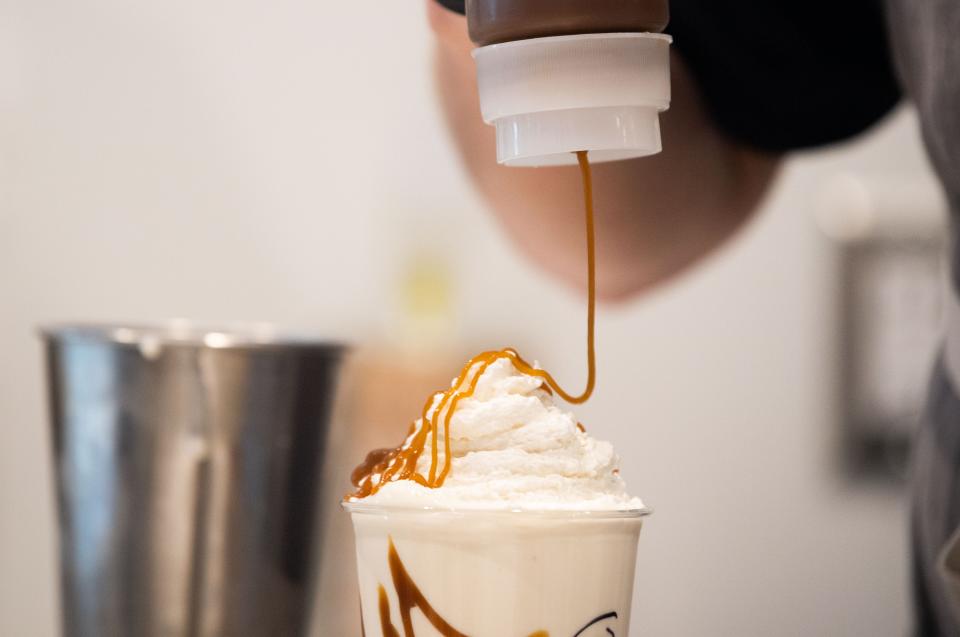 Caramel is drizzled over a boozy milkshake at Goo Goo Chocolate Co.'s downtown storefront in Nashville.