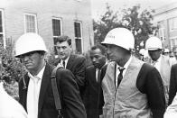 FILE- In this Oct. 1, 1962, file photo, James Meredith, center, is escorted by federal marshals as he appears for his first day of class at the previously all-white University of Mississippi, in Oxford, Miss. "Walk Against Fear: James Meredith," scheduled to air Thursday, Oct. 1, 2020, on the Smithsonian Channel, examines the life of a U.S. Air Force veteran-turn-human right agitator whose admission into the University of Mississippi forced President John F. Kennedy to send federal troops into the state to quell a white supremacy uprising. It was one of the most violent moments of the Civil Rights Movement and it forever changed life in the American Deep South. (AP Photo, File)