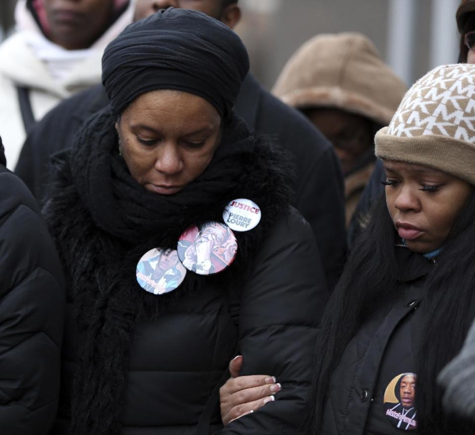 Arewa Karen Winters, left, and Tambrasha Hudson, the great aunt and mother of Pierre Loury, join other protesters at a news conference outside the Chicago Police District 1 headquarters on South State Street in Chicago on Friday, Jan. 13, 2017. Speakers were critical of the mayor and the police department and said Chicagoans already knew from experience what the Department of Justice said in its report critical of the Chicago Police department. (Terrence Antonio James/Chicago Tribune via AP)