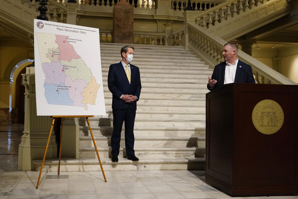 James Stallings, director of Georgia Emergency Management and Homeland Security, right, speaks as Gov. Brian Kemp looks on during a news conference to discus the state's COVID-19 vaccine distribution plans Thursday, Feb. 18, 2021, in Atlanta. (AP Photo/John Bazemore)