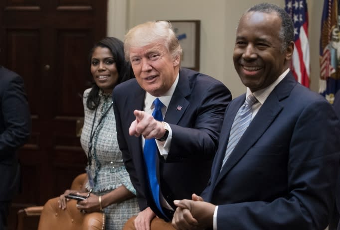 resident Donald Trump holds an African American History Month listening session attended by nominee to lead the Department of Housing and Urban Development (HUD) Ben Carson (R), Director of Communications for the Office of Public Liaison Omarosa Manigault (L) and other officials in the Roosevelt Room of the White House on February 1, 2017 in Washington, DC. 
