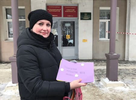 Irina Christensen, wife of Dennis Christensen, a Jehovah's Witness accused of extremism, poses for a picture while holding letters of support for her husband outside a court building in the town of Oryol, Russia January 15, 2019. REUTERS/Andrew Osborn