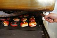 FILE PHOTO: Bagels in the colours of the Toronto Raptors emerge from an oven at What A Bagel bakery in Toronto