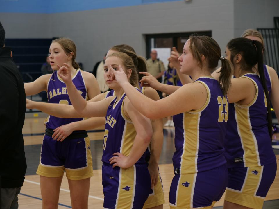 The Dalhart Lady Wolves prepare to break from a timeout during a 3A bi-district playoff game against Idalou on Wednesday, February 15, 2023 at West Plains High School