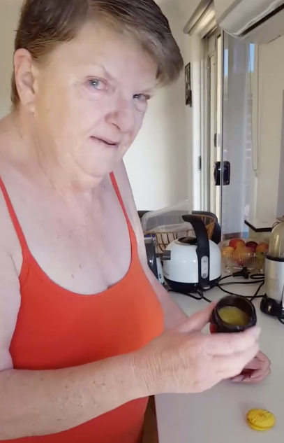 Jill Radford spreads some of the CBD oil onto a biscuit in the morning and evening. Source: Leon Cameron