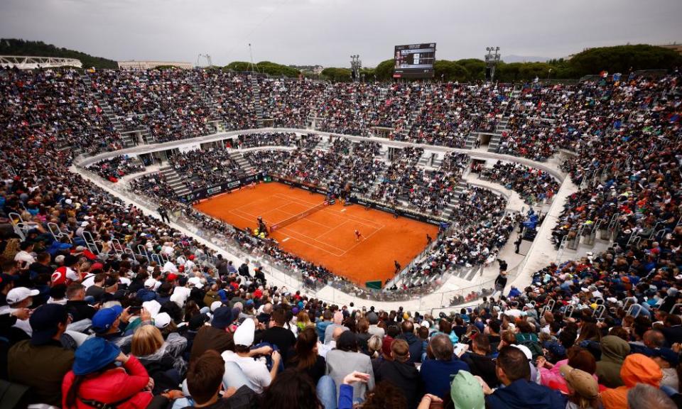 Casper Ruud is at the rear of the court as he readies a return of Holger Rune’s serve in their Italian Open semi-final.