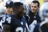 Oakland Raiders quarterback Derek Carr (4) and teammates warm up for an NFL preseason football game against the Green Bay Packers on Thursday, Aug. 22, 2019, in Winnipeg, Manitoba. (John Woods/The Canadian Press via AP)