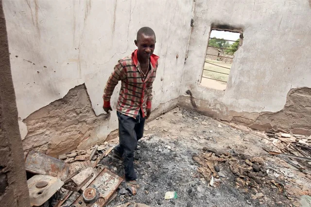 The choir master Patrick Onmepe walks among debris of the burnt building of St. Peter Catholic Church following attacks by Fulani herdsmen at Agatu community in Benue State, north-central Nigeria, on May 10, 2016. (AFP/EMMANUEL AREWA) 